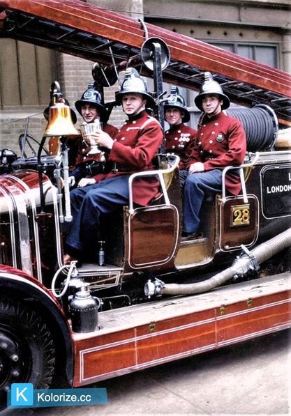 [colorized] A photograph from circa 1930 of Whitechapel fireman holding the trophy they won in the 'Fire Brigades Escape Competition'