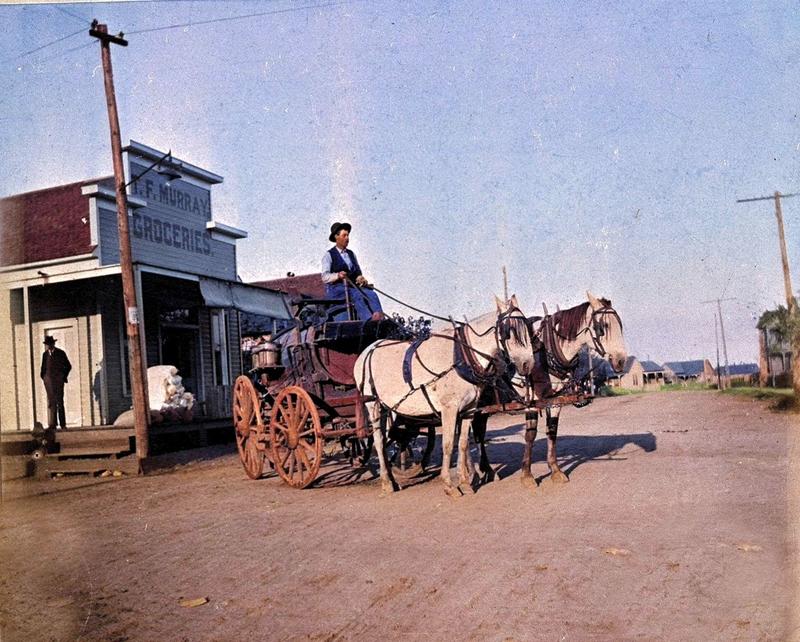 [colorized] From the wonderful UTA Special Collections archives, Robert Johnson, outside T. F. Murray Groceries, hauls water to "Irish Town," area east of the Santa Fe depot in Fort Worth, 1895. 