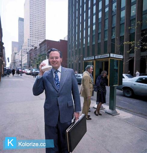[colorized] Motorola engineer John Mitchell with his phone on the streets of New York. Mitchell helped develop the design for the first mobile phone. 1973.