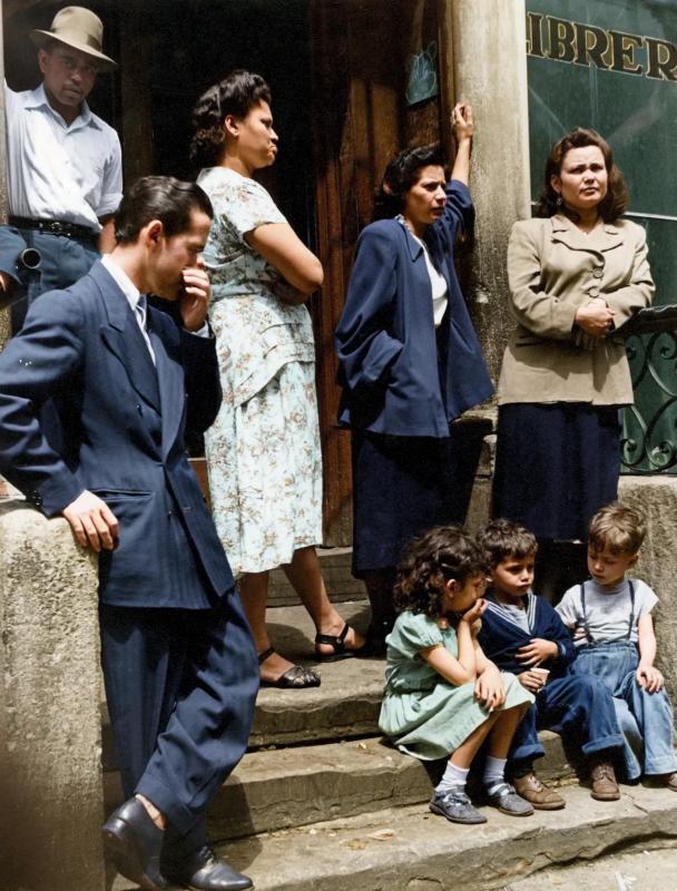 [colorized] Schomburg Center for Research in Black Culture, Photographs and Prints Division, The New York Public Library. "Group of men, women and children gathered on stoop, East Harlem, New York City" The New York Public Library Digital Collections. 1947 - 1951.