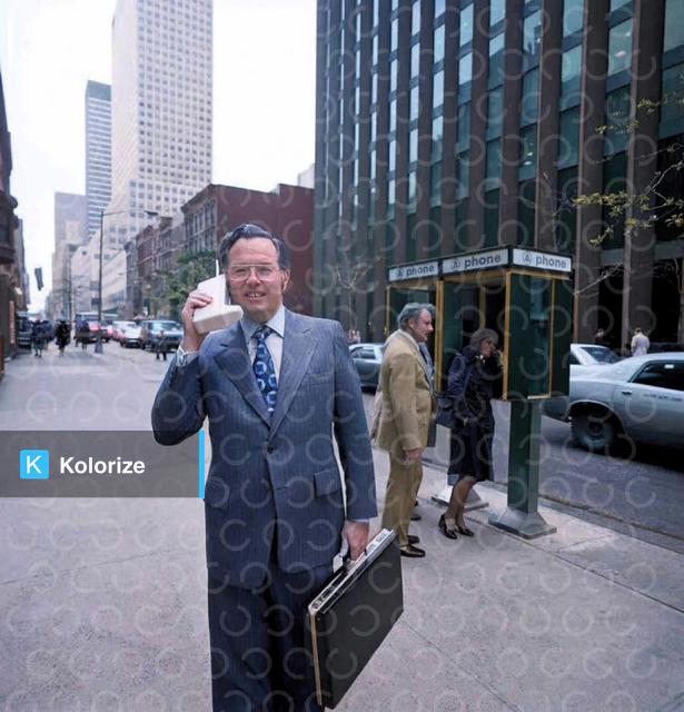 [colorized] Motorola engineer John Mitchell with his phone on the streets of New York. Mitchell helped develop the design for the first mobile phone. 1973.