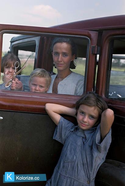 [colorized] A family of a migratory fruit worker from Tennessee camped in a field near the packinghouse at Winter Haven, Florida, 1937.