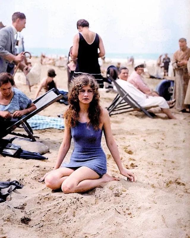 [colorized] Female swimmer posing on the beach. 1925.