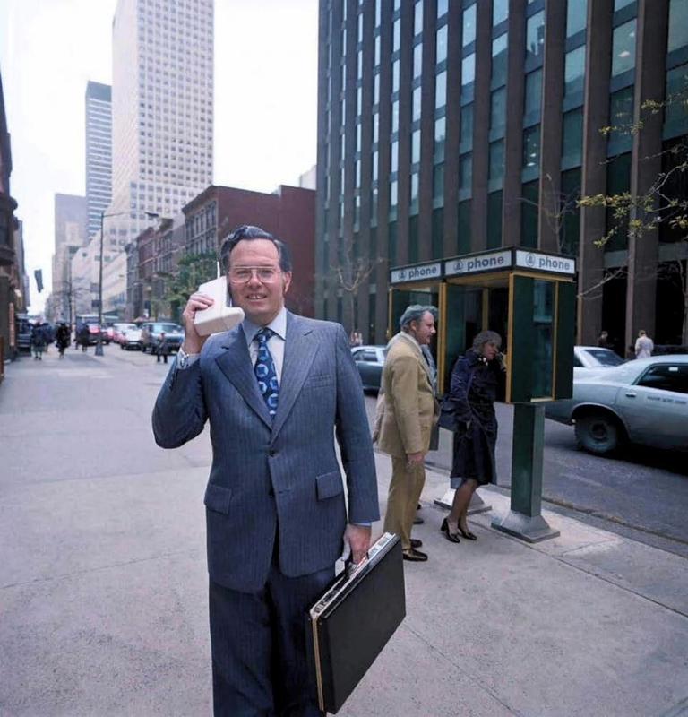 [colorized] Motorola engineer John Mitchell with his phone on the streets of New York. Mitchell helped develop the design for the first mobile phone. 1973.