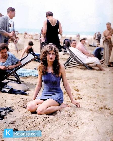 [colorized] Female swimmer posing on the beach. 1925.