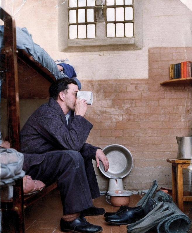 [colorized] A photograph of a prisoner in a typical cell at Leicester Prison 
Taken in 1959.