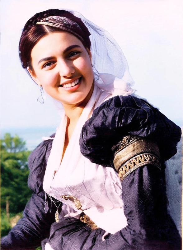 [colorized] A woman in traditional dress in Greece, 1950.
